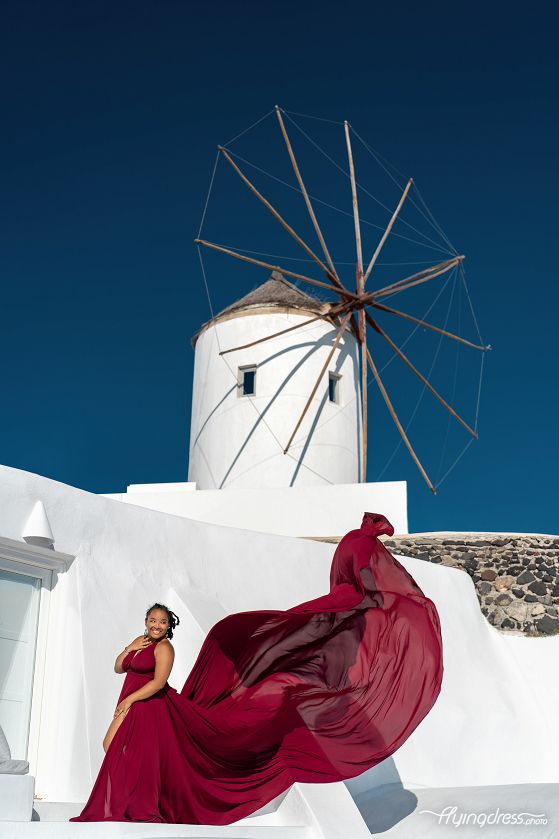 Santorini flying dress photoshoot in Oia village close to the windmill