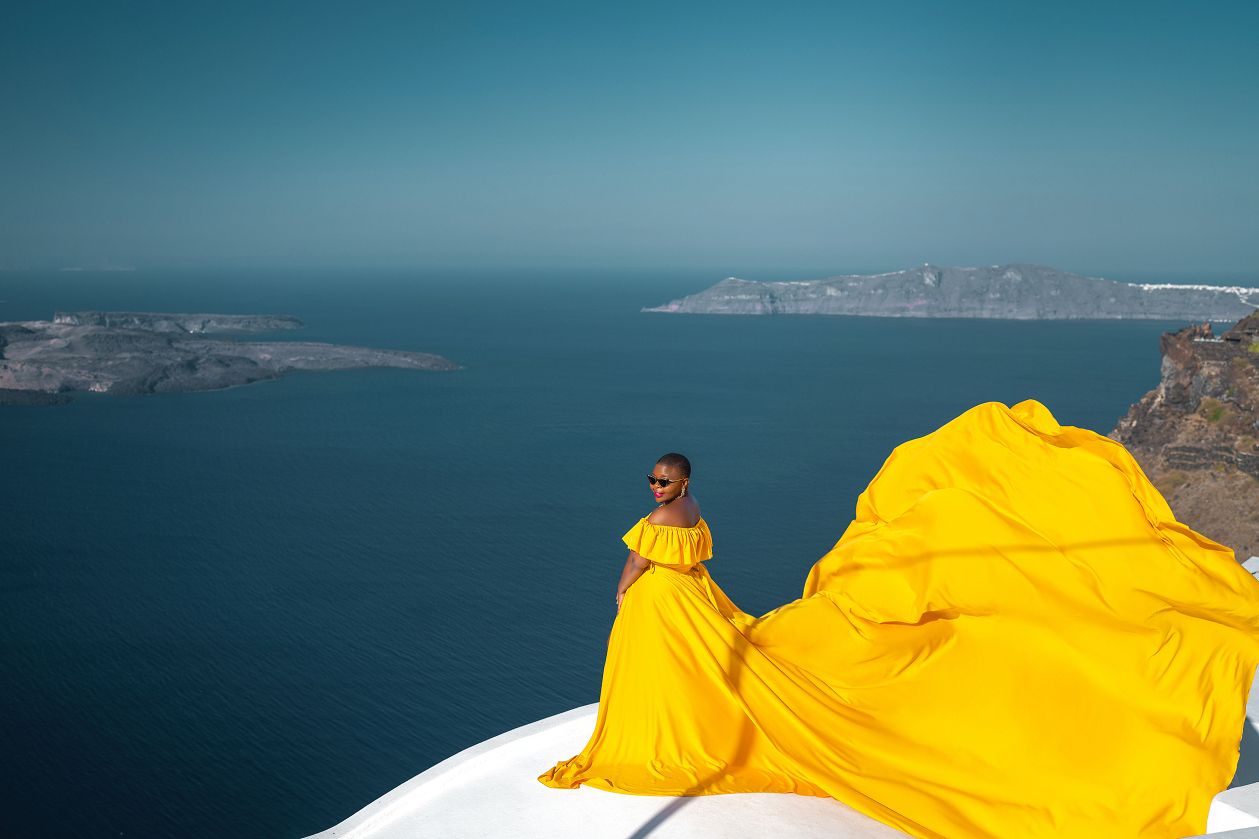 Black girl wearing a yellow Santorini dress
