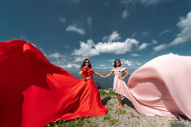 Mom and daughter photoshoot with a red and pink flying dress in Santorini