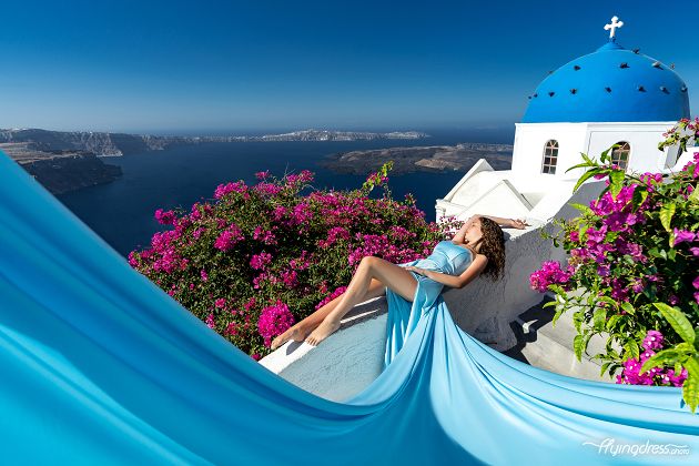 Flying dress shoot by the blue dome in Santorini, Greece
