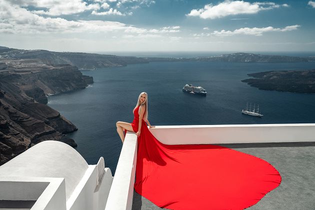 Red long dress photoshoot in Santorini, Greece with caldera view