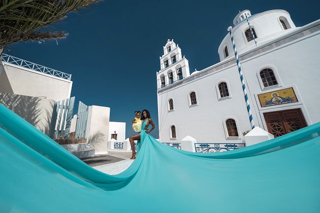 Photoshoot in Oia, Santorini with a tiffany blue flying dress