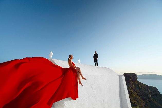 Red flying dress photoshoot in Santorini, Greece