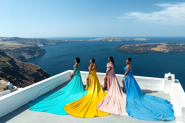Santorini flying dress group photoshoot with caldera and volcano view