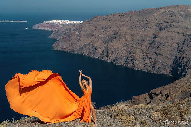 Santorini flying dress photoshoot with caldera and Oia view