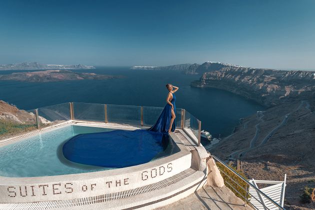 Photoshoot at the pool in Santorini with a long blue dress