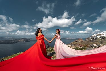 Mom and daughter photoshoot with a flying dress in Santorini