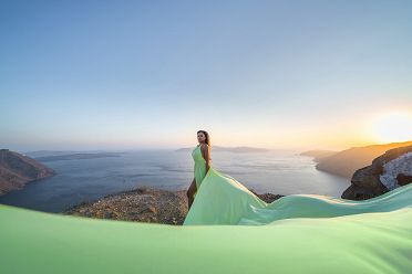 Sunset photoshoot with a green flying dress