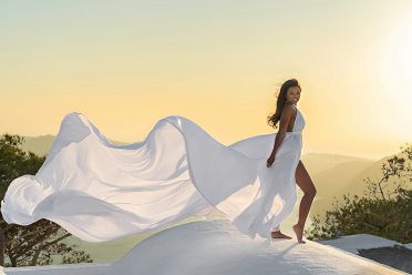 Sunset shoot with a white flying dress in Santorini